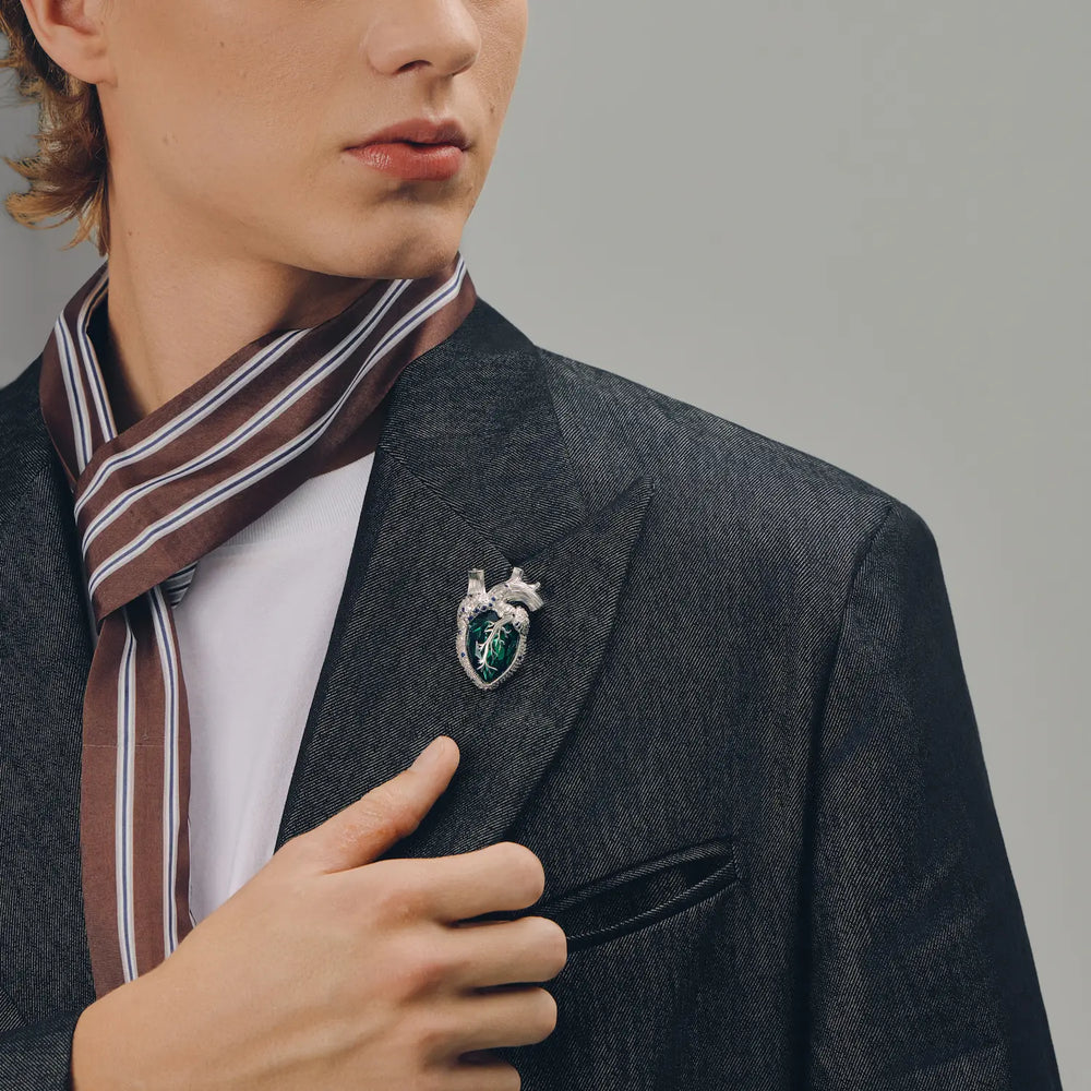Emerald crystal anatomical heart brooch with silver-tone details