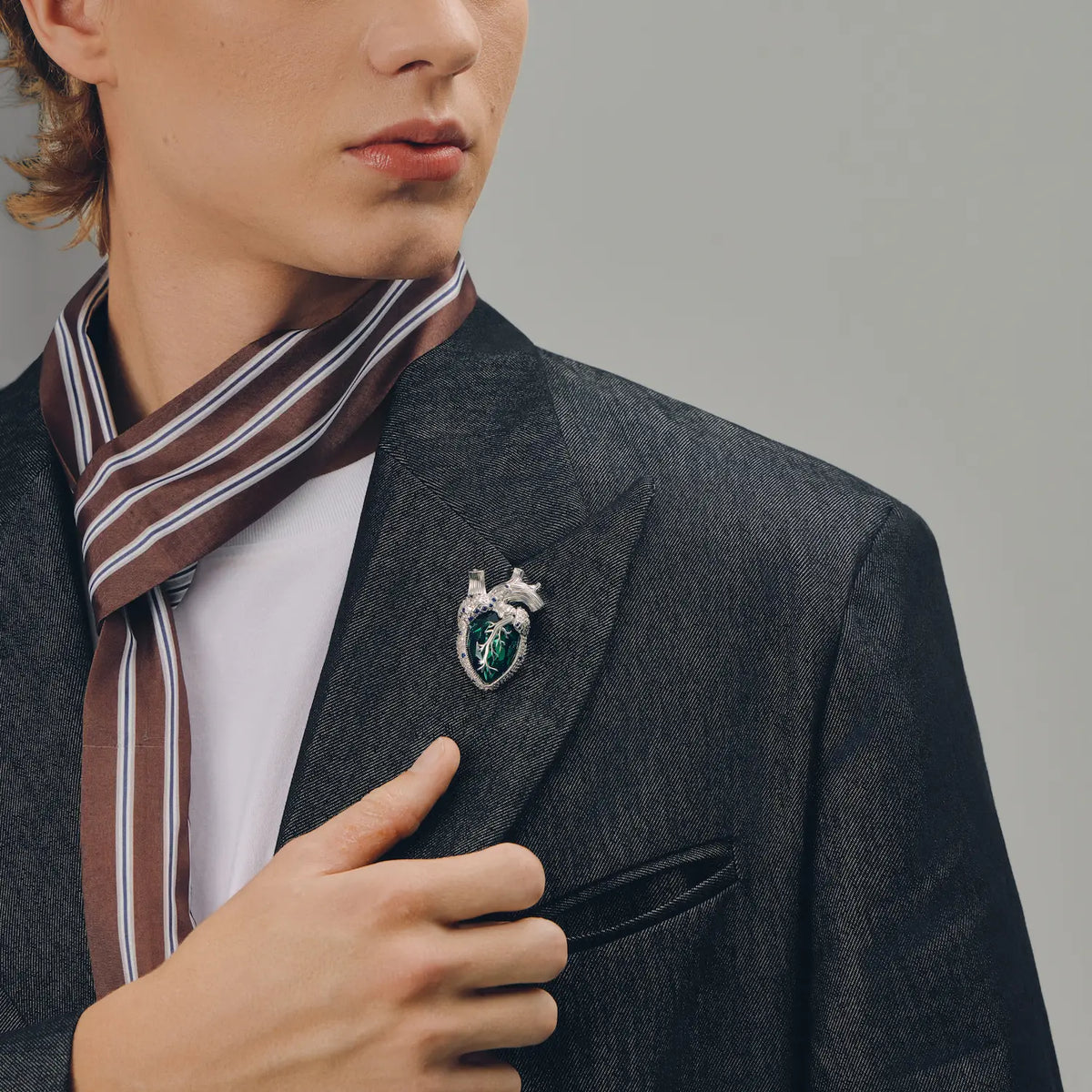 Emerald crystal anatomical heart brooch with silver-tone details